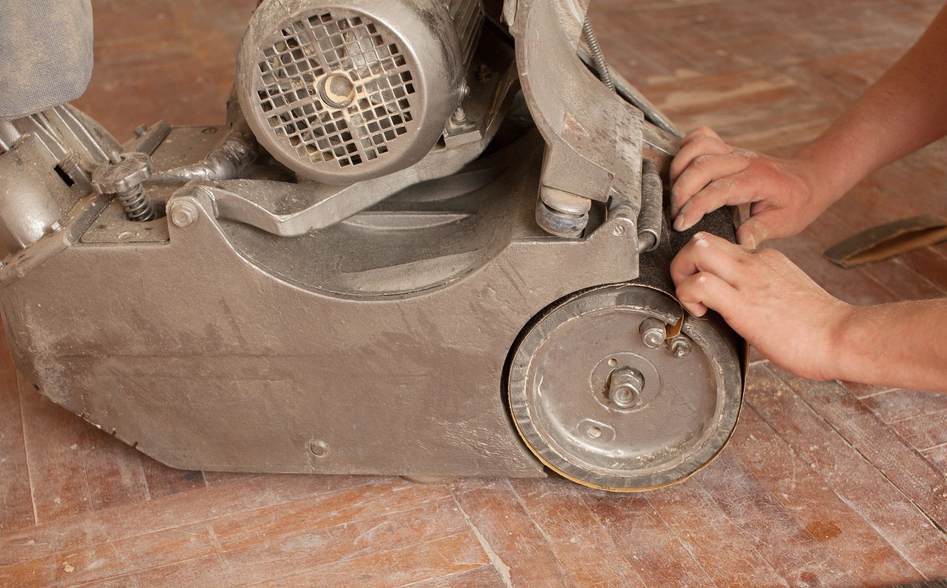 Wood floor polishing maintenance work by grinding machine. close-up